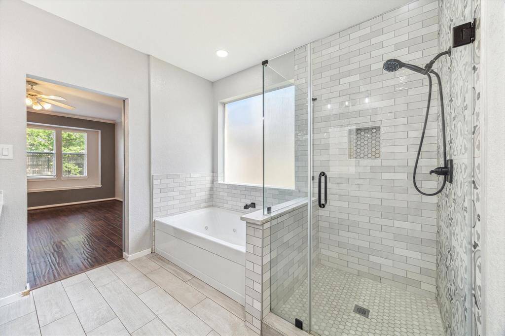 Primary suite featuring a lovely barn door to the ensuite bath.