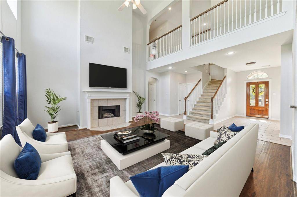 Living area is expansive with ample natural light. This photo has been virtually staged.