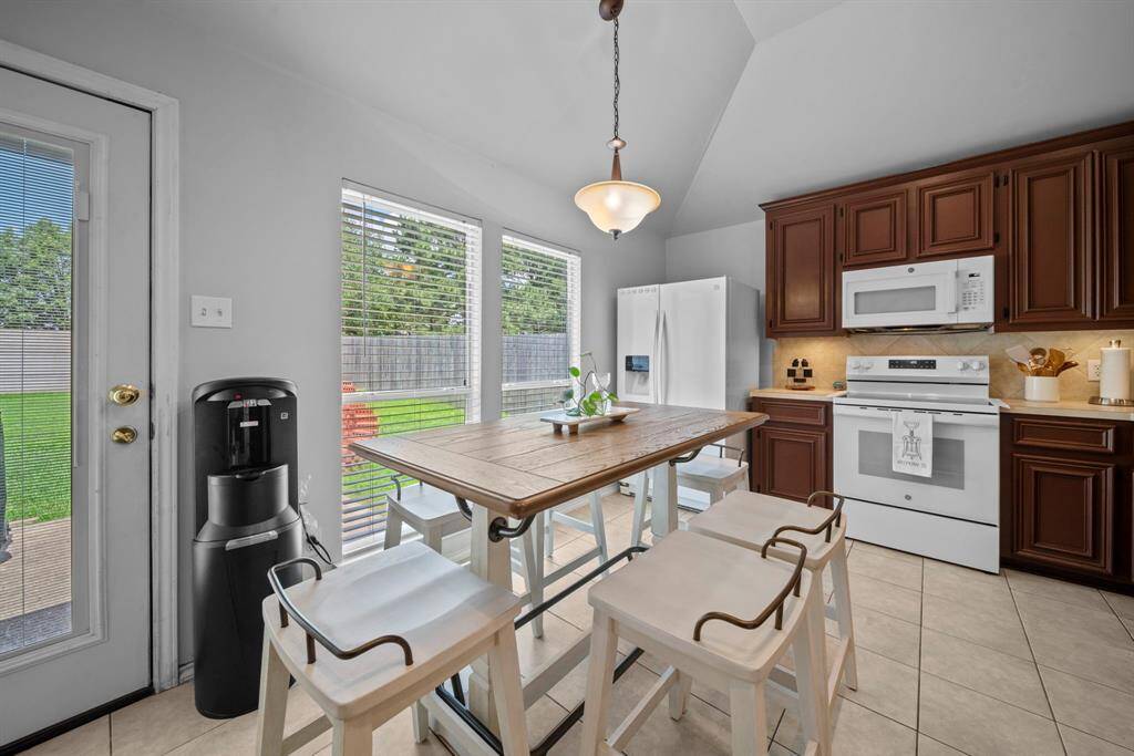 Charming breakfast nook with large windows for natural light and a view of the backyard.