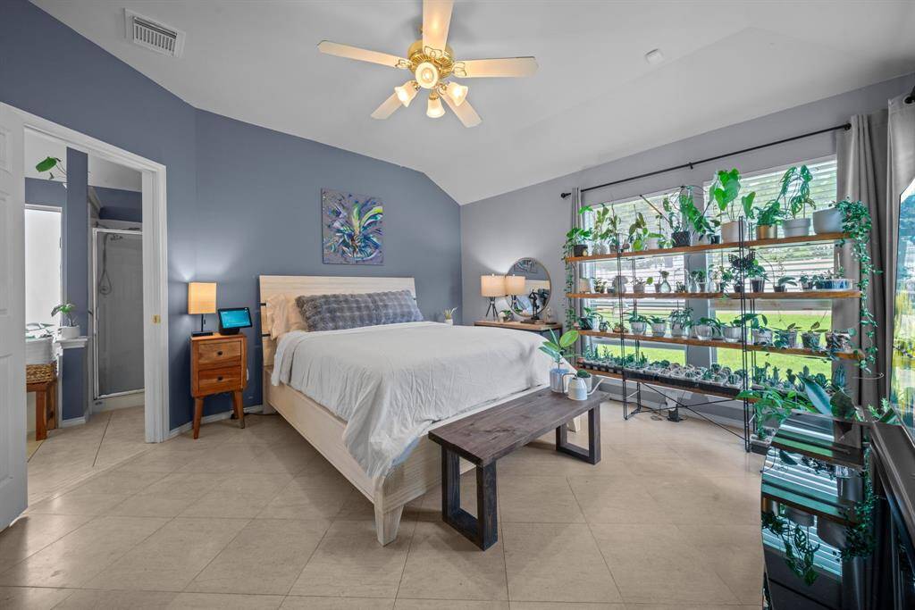 Spacious primary bedroom with large windows and an en-suite bathroom.