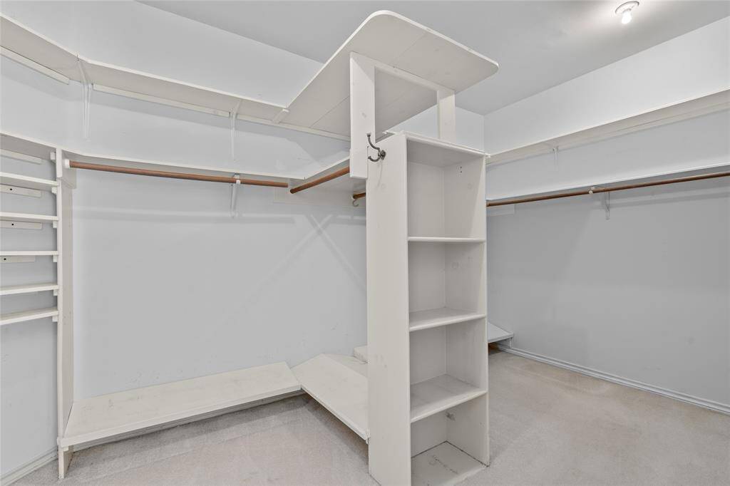 Your large primary walk-in closet provides ample shelving and hanging space as well as a central island for additional storage.