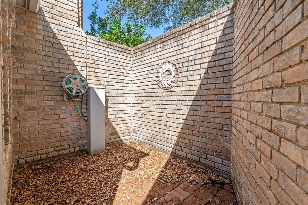 Your enclosed outdoor space off the primary bedroom has brick walls and a brick floor. Ideal for a private sanctuary.