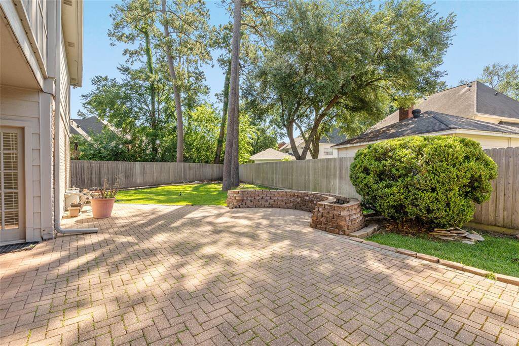 The view from your dining room doors looking onto the paved patio area.