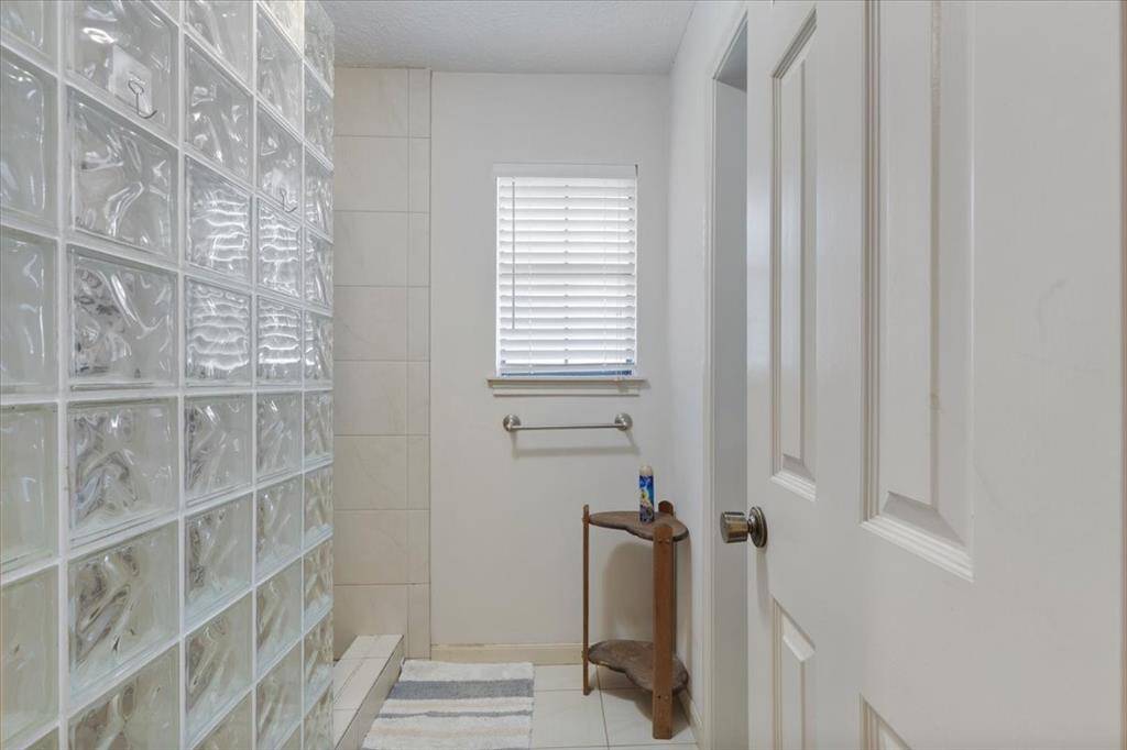 Shower ony with a vintage glass splash quard.