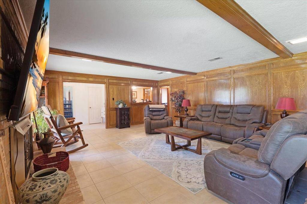 Elegant wooden beams in the family room with a gas fireplace.