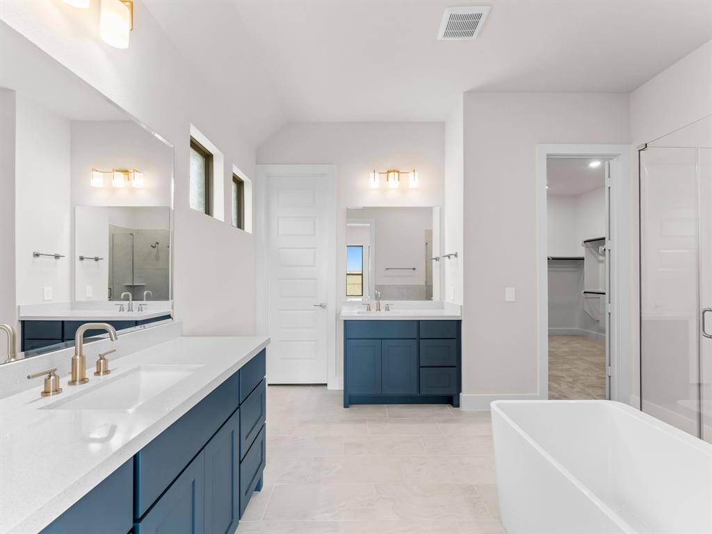 Primary Bath wit Separate Vanities, Enclosed Toilet, and Freestanding Tub