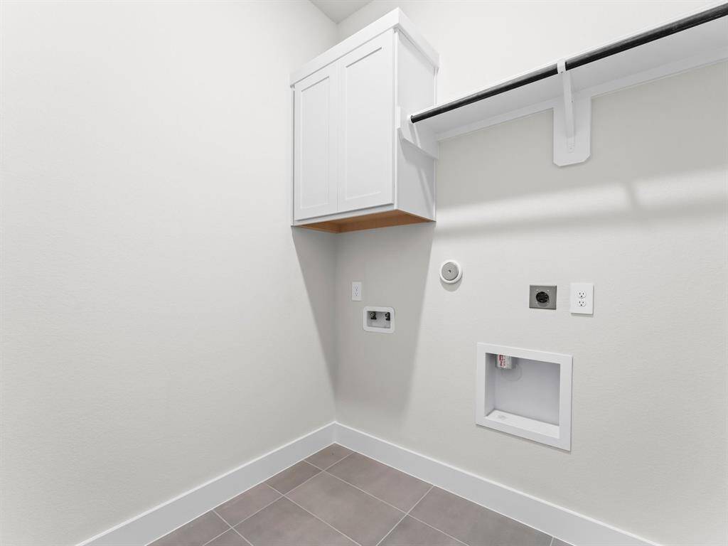 Utility Room with Washer and Dryer Connections, Storage Cabinet, and Hang to Dry Bar