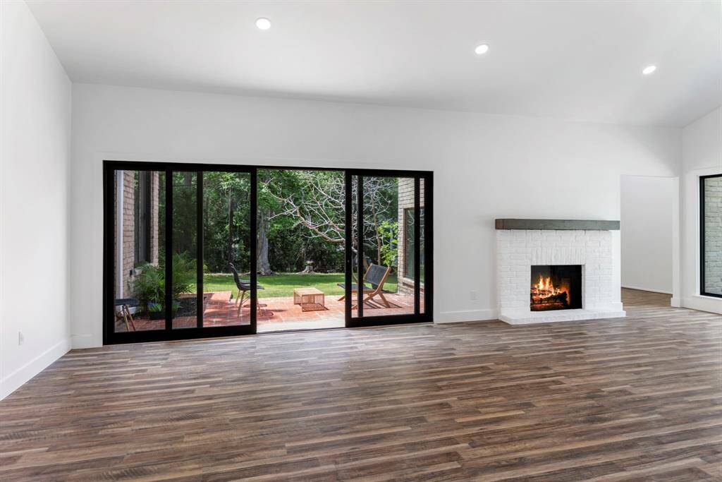 Sliding doors in the family room enlarge the entertaining space, connecting to the gorgeous back porch.