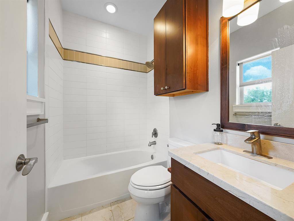 Indulge in the luxury of an ensuite bathroom in the secondary bedroom! Featuring a stylish vanity with ample storage, a cabinet, and a convenient tub/shower combo.
