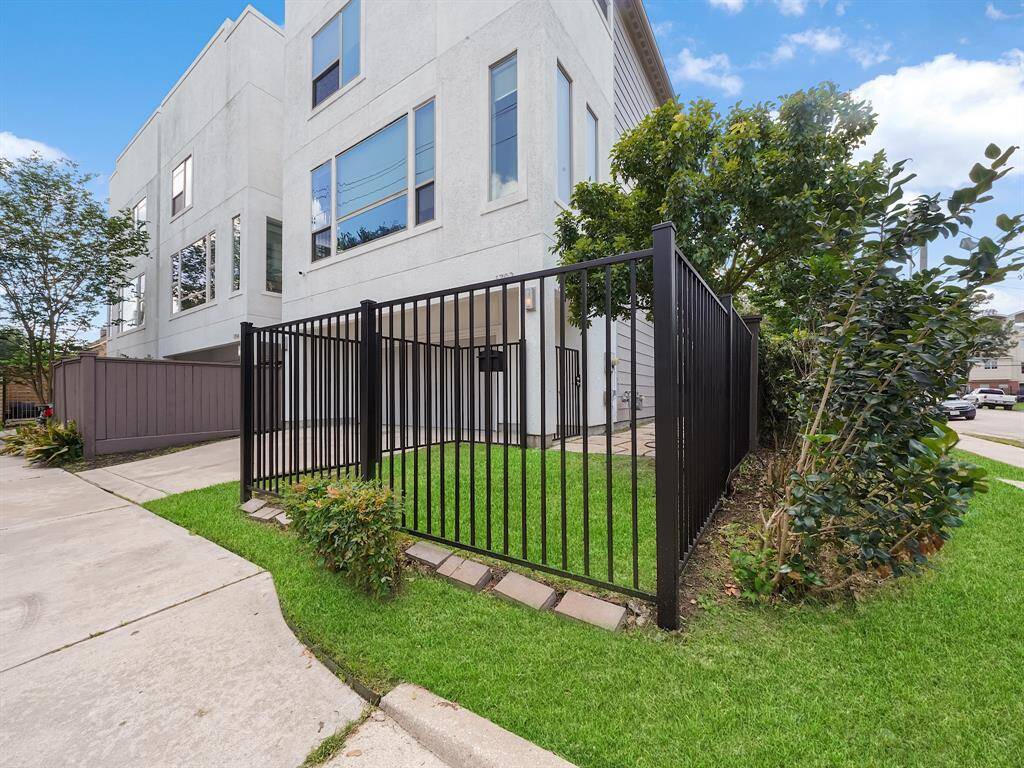 Enjoy a low-maintenance outdoor space! This property features a fenced area with a small grassy section, perfect for easy living.