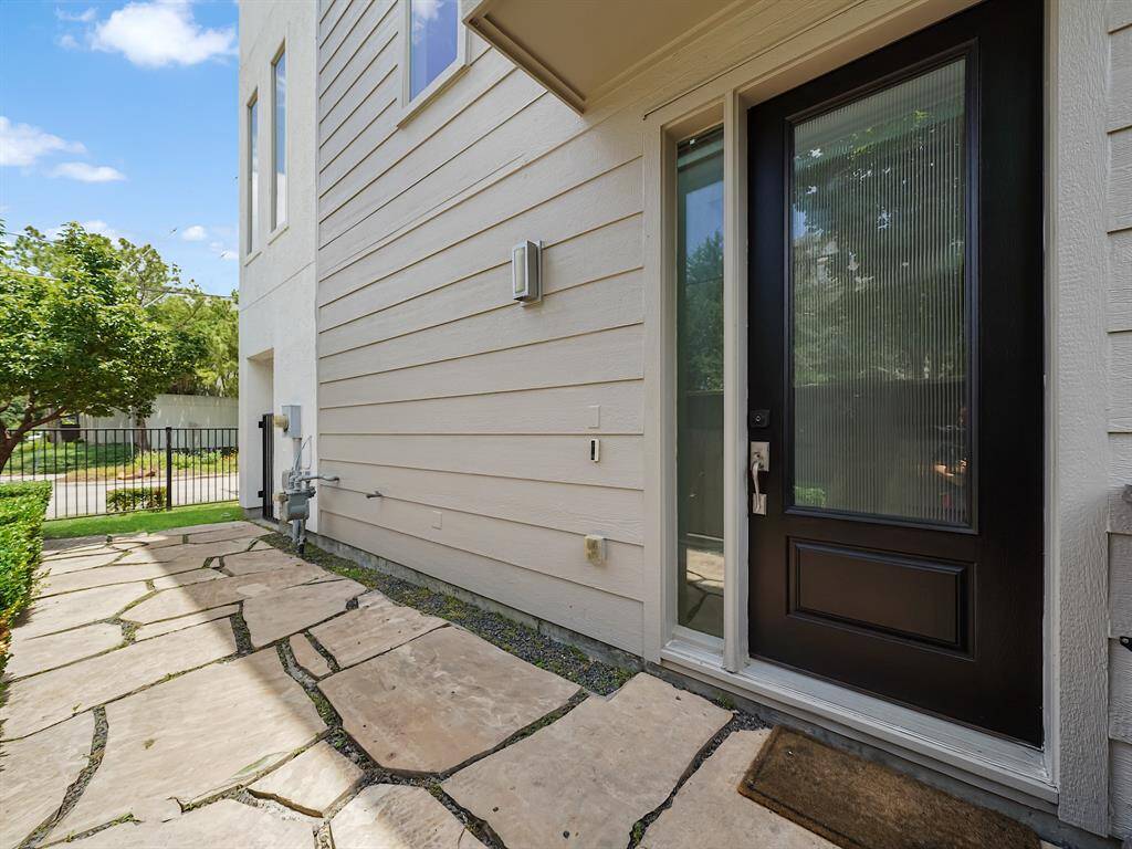 Enjoy easy access to this home via a side entry walkway featuring charming flagstone pavers and low-maintenance gravel, blending functionality with understated style.