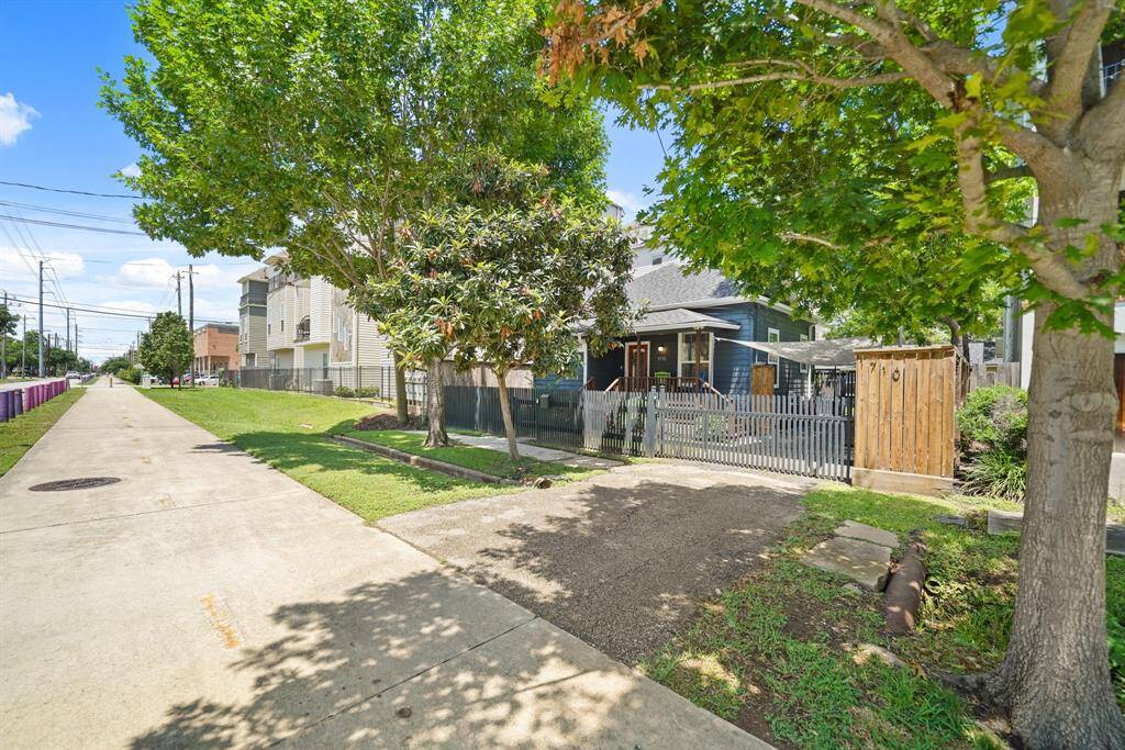 Charming home with a welcoming front porch, nestled behind a picket fence. Located on a quiet street with a sidewalk. Ideal for enjoying outdoor activities and neighborhood strolls.