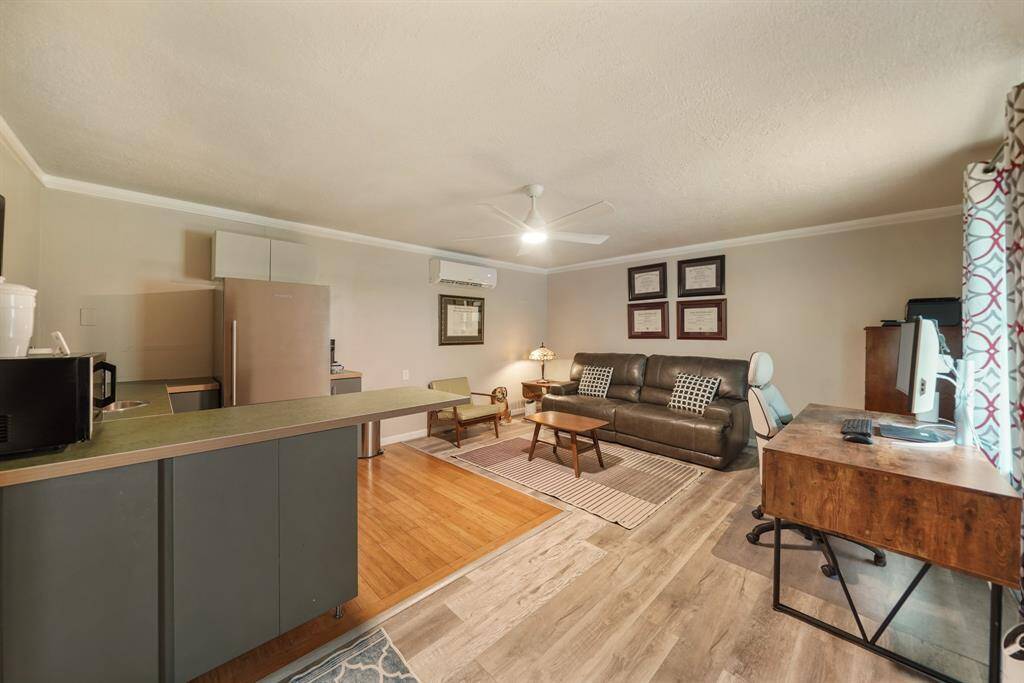 This cozy living space features an open layout with a small kitchen area, modern appliances, and a comfortable seating area.