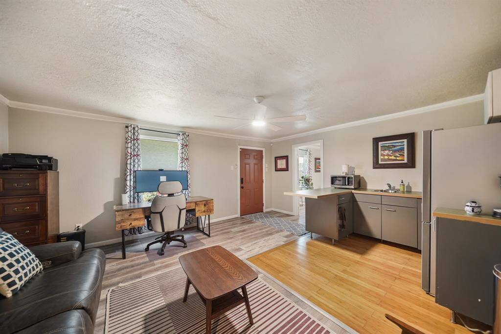 This cozy living space features a comfortable seating area, and natural light fills the room, highlighting flooring.