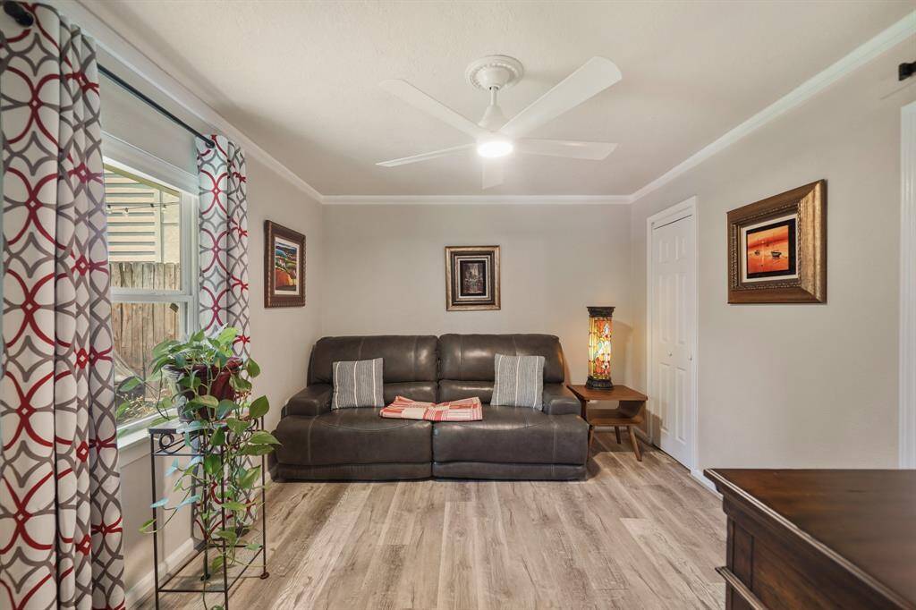 This bedroom features neutral walls and flooring with a window that provides natural light.