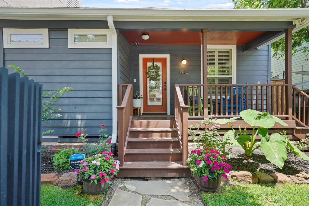 Charming bungalow with a painted exterior in a stylish blue with white trim, offering a modern, inviting look.