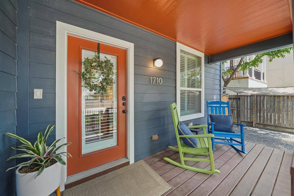 Charming front porch with a colorful, inviting entrance and a welcoming atmosphere perfect for relaxation.