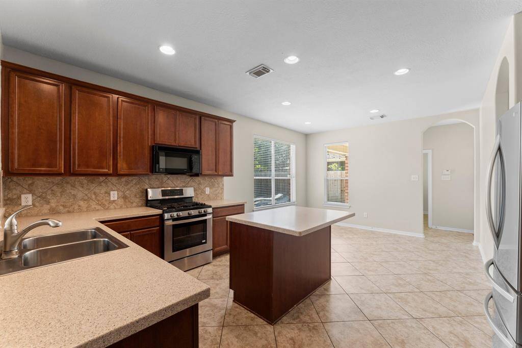 The kitchen features ample cabinet space