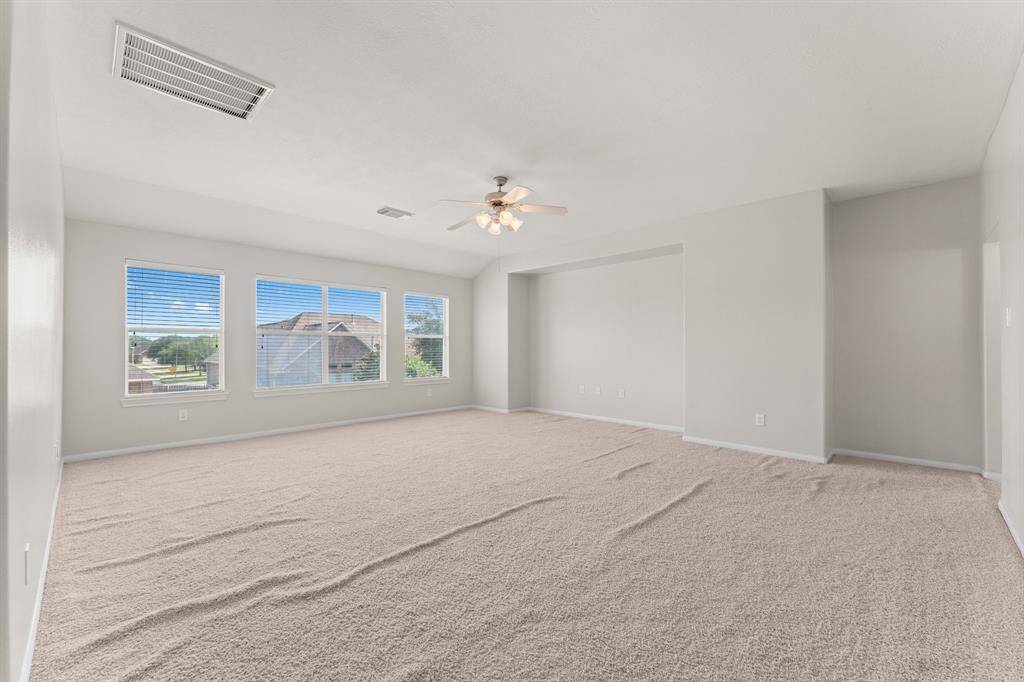 Spacious centrally located game room with views of the backyard