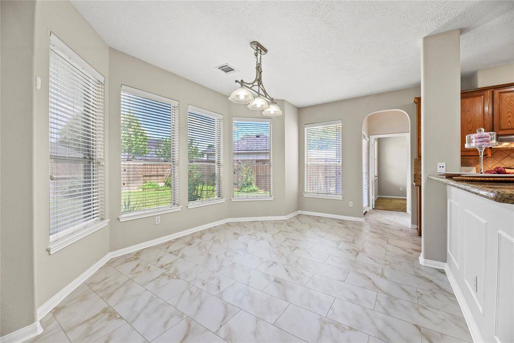 Light and bright breakfast area with backyard views.