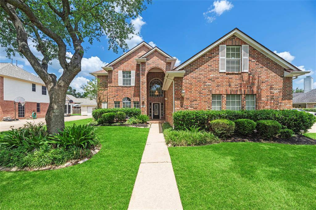 This beautiful 2-story home with lush landscaping has great curb appeal.