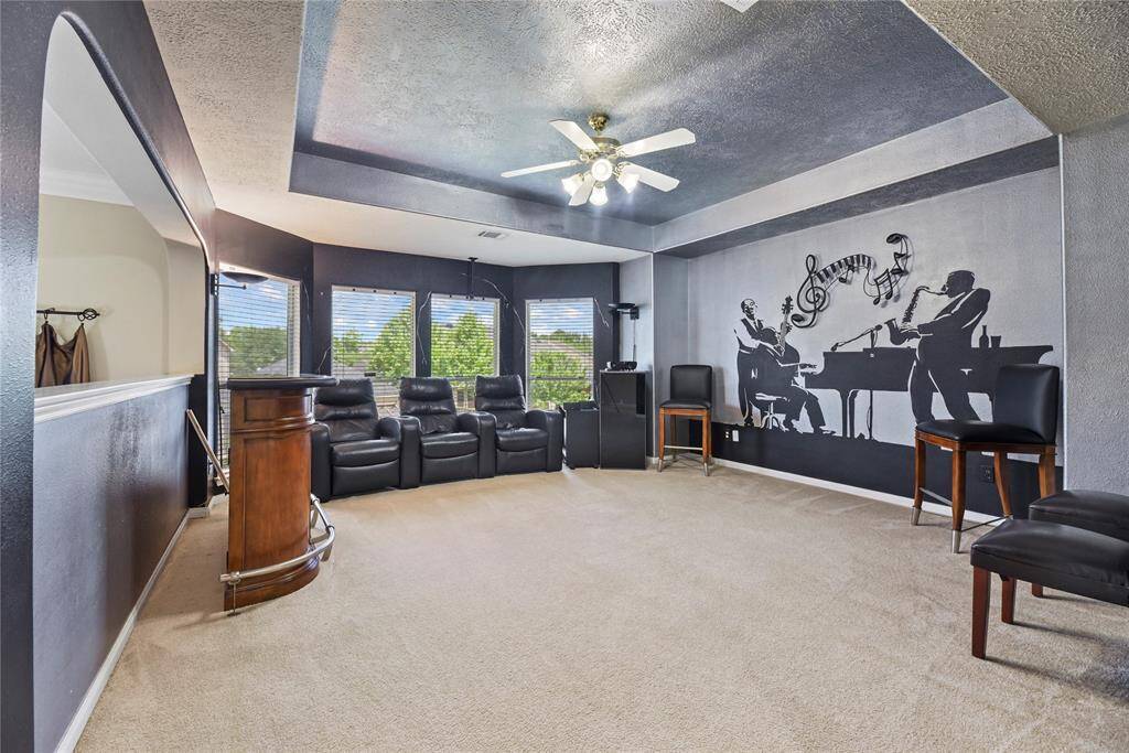 Versatile upstairs game room with a projector and 109" pull down screen.