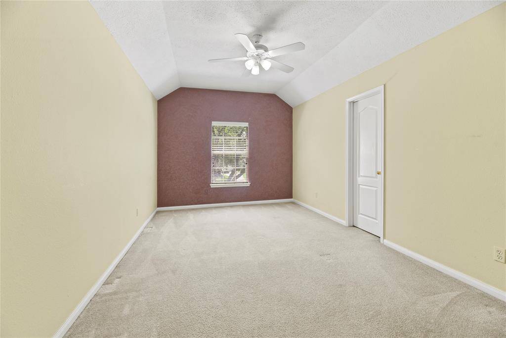 Upstairs bedroom with a high ceiling and large closet.