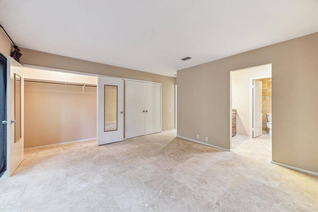 Abundant storage with custom drawers, enhanced by natural light and the privacy of a separate shower and toilet area.