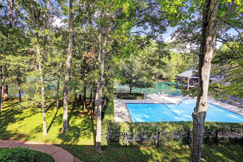 Large windows flood the space with natural light, providing stunning views of the surrounding landscape.