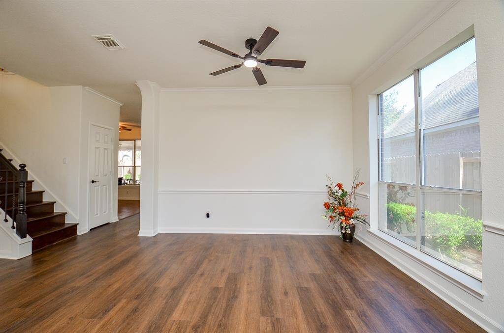 View of the formal living room with new ceiling fan and light