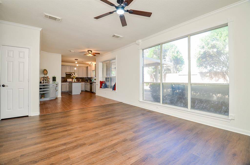 Big picture windows in the family room showcases a relaxing backyard that is so easy to maintain
