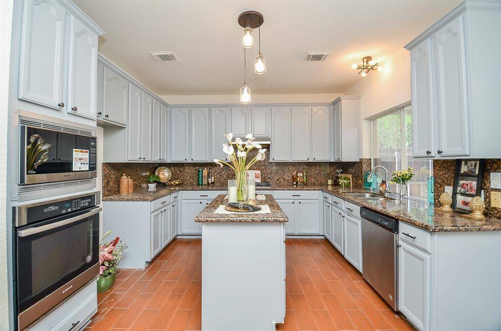 Newly painted kitchen cabinets in this spacious chef kitchen