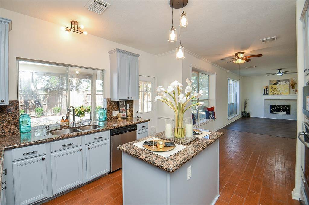 Wood look tiles in the kitchen makes it so easy to clean and maintain.  Check out the backyard while you wash the dishes