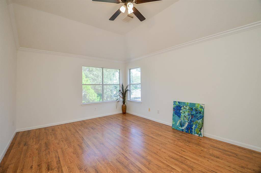 Primary Bedroom has crown molding and wood laminate flooring