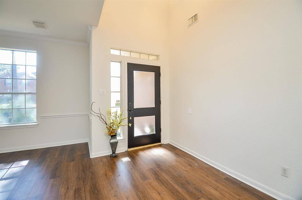 Two story foyer leads to a formal living room and dining room