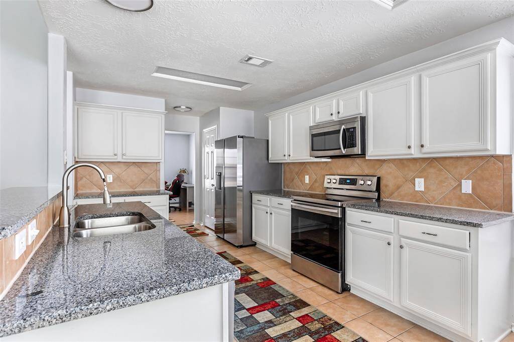 View of kitchen from breakfast area