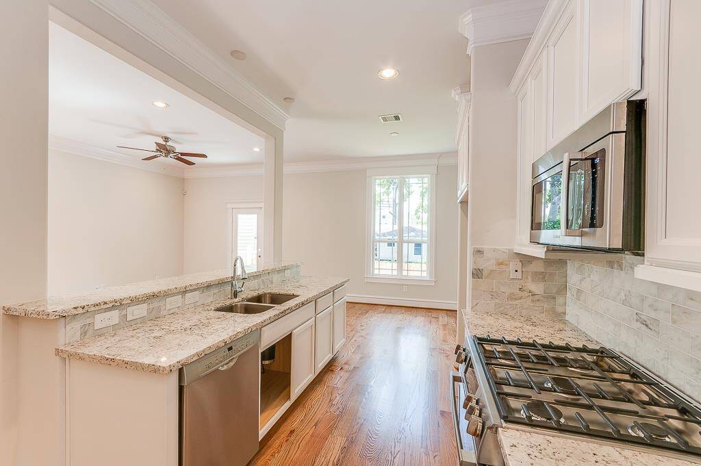 white cabinets, attractive counters stainless appliances