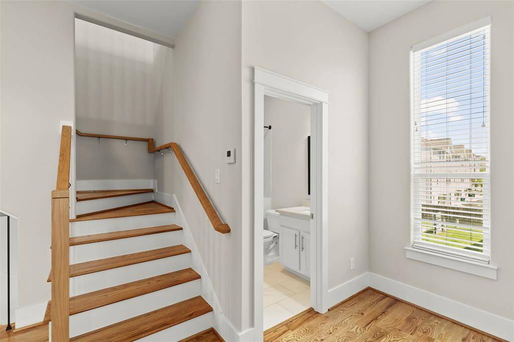 this home has an abundance of natural light, shown here is the secondary bath and staircase to the flex/gameroom