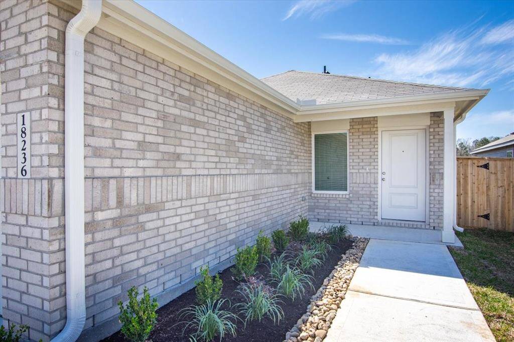 A closer look at the covered front porch, offering both convenience and a welcoming space to relax and enjoy.