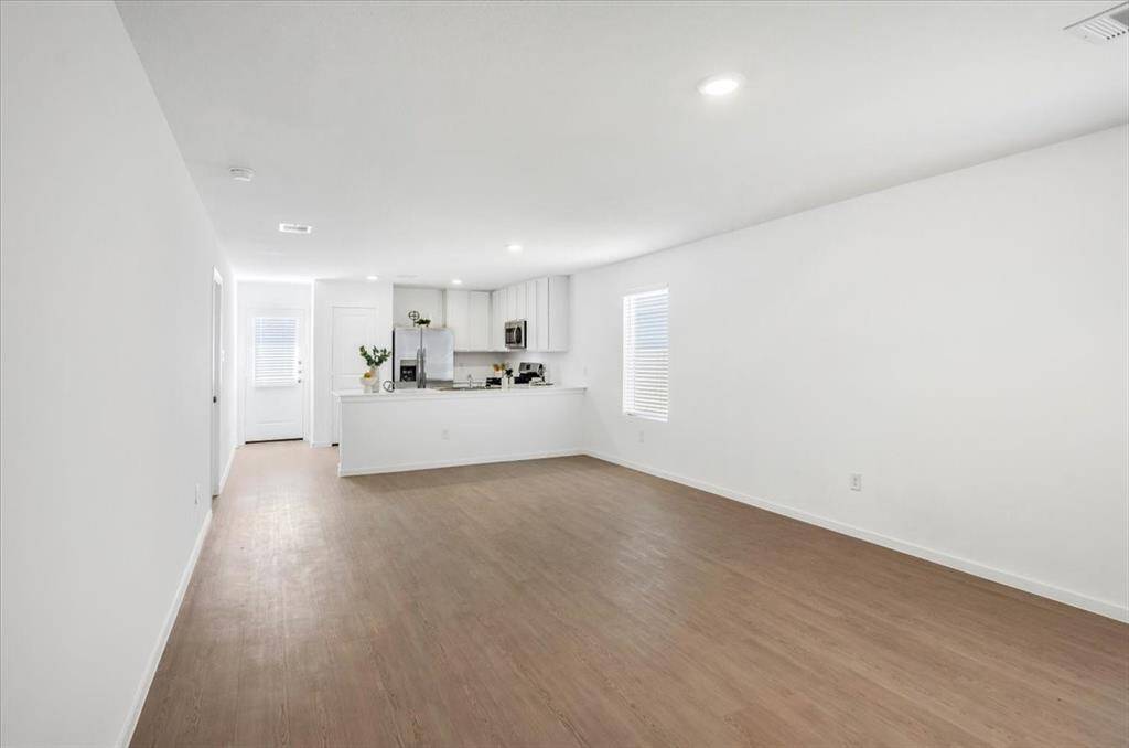The open and spacious layout connects the kitchen seamlessly to the living and dining areas, creating a bright and inviting space perfect for everyday living and entertaining.