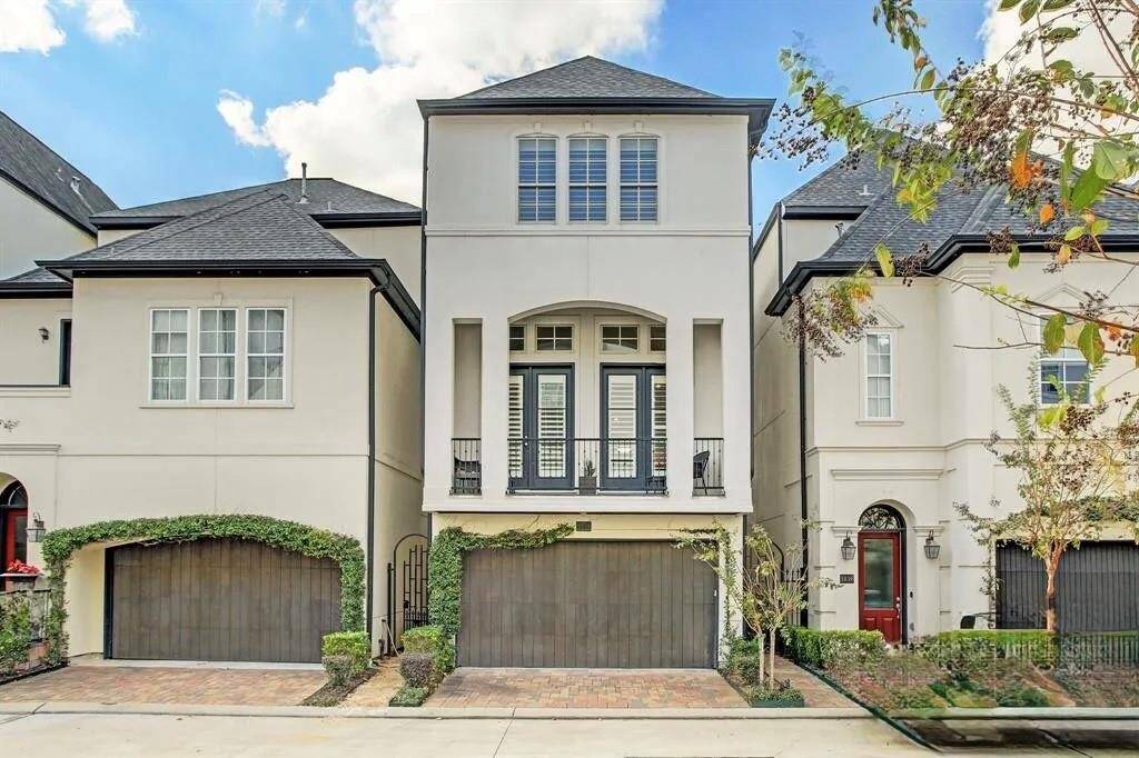 Welcome to 1835 Upland Lakes! This is a modern, three-story townhouse with a clean exterior, featuring a two-car garage and a balcony on the second floor.