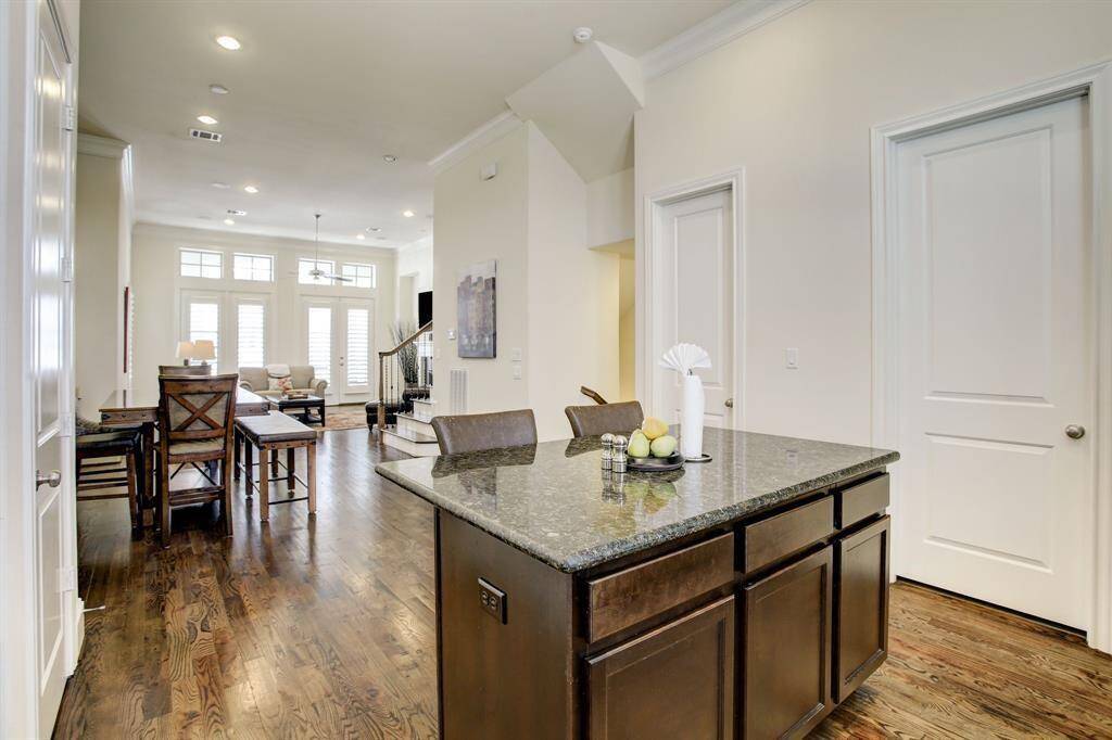 Large windows and glass doors in the living room allow plenty of natural light, creating an inviting atmosphere.