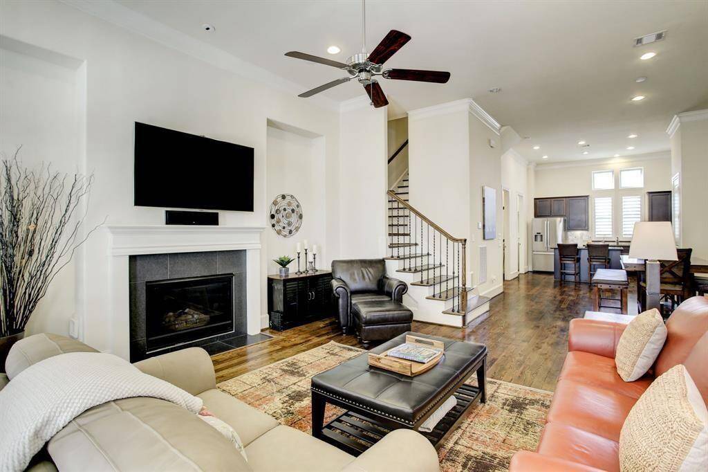 The room flows seamlessly into a staircase leading upstairs.