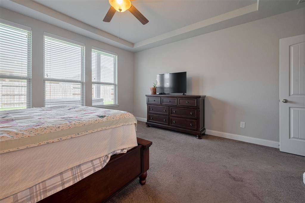 Large primary bedroom with gorgeous tray ceiling!