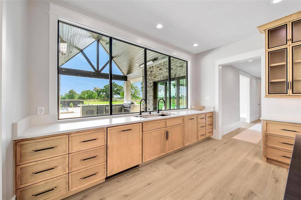 Prep your gourmet meal while looking out the large picture windows over the covered patio.  Cabinetry is custom fitted to cover the dishwasher and refrigerator Large drawers are great for storing plenty of kitchen essentials. Double Over with removeable rotisserie feature and self-cleaning convection oven.