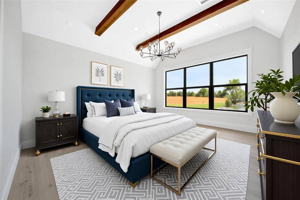 The Primary bedroom features wood accents and modern lighting. Spacious enough for any combination of furniture arrangements.