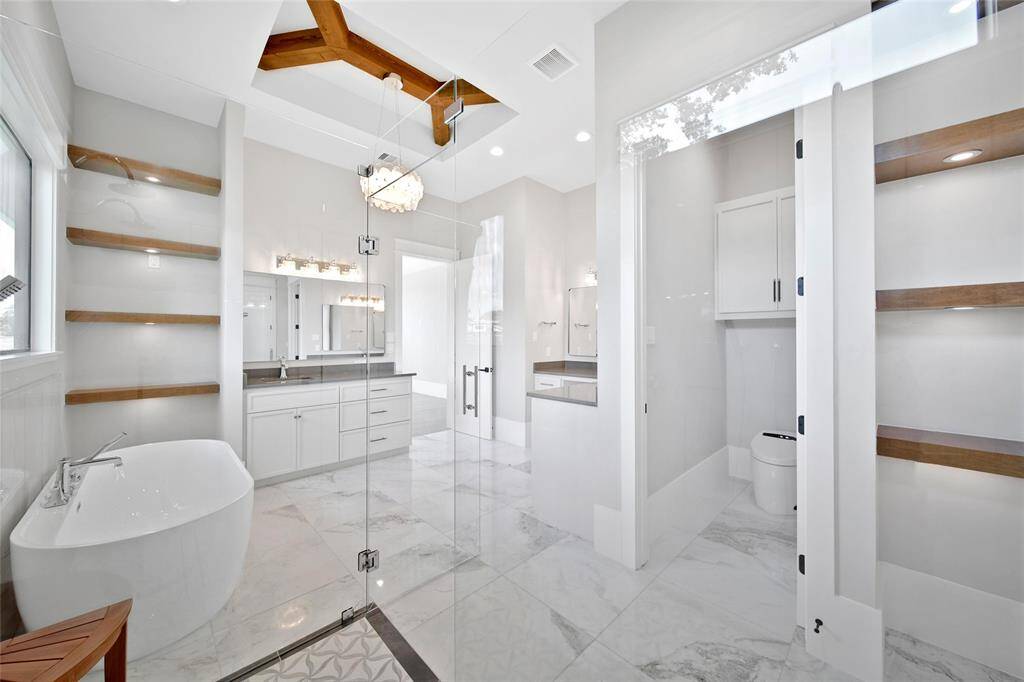 Accent lighting, wood beam, natural stone tie in with the look and feel of the entire home.