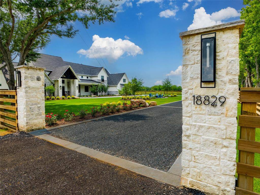Dramatically welcome guests into your home with style.  Fully lit columns and driveway add a beautiful touch as guests drive around the front entrance with a complete view of this carefully crafted and tastefully designed exterior and landscape.