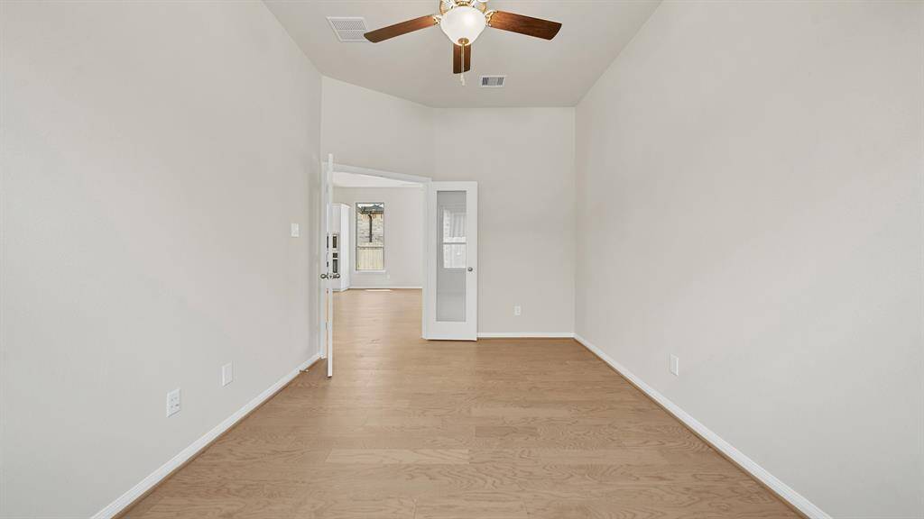 The Sophisticated Study, adjacent to the Luxurious Living Room, offers handsome hardwood flooring, ceiling fan and French door access.