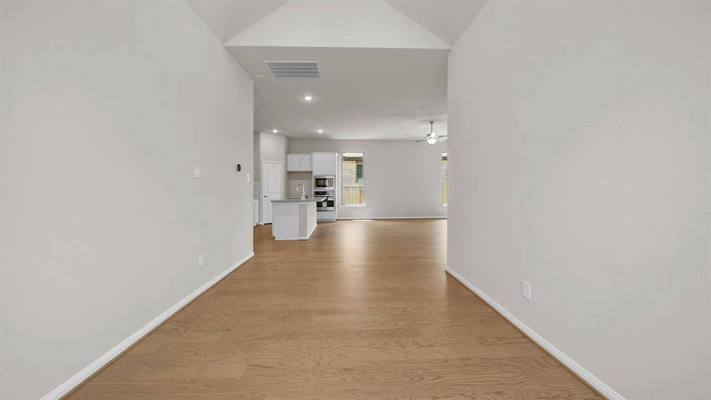 Another view of the Dedicated Dining Room with handsome hardwood flooring, raised ceilings and abundance of space for hosting gatherings.